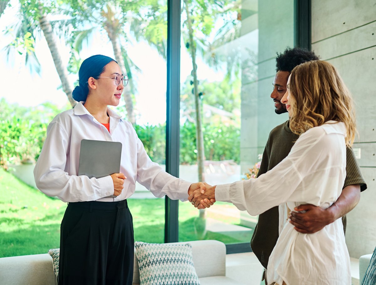 A real estate agent with a young couple