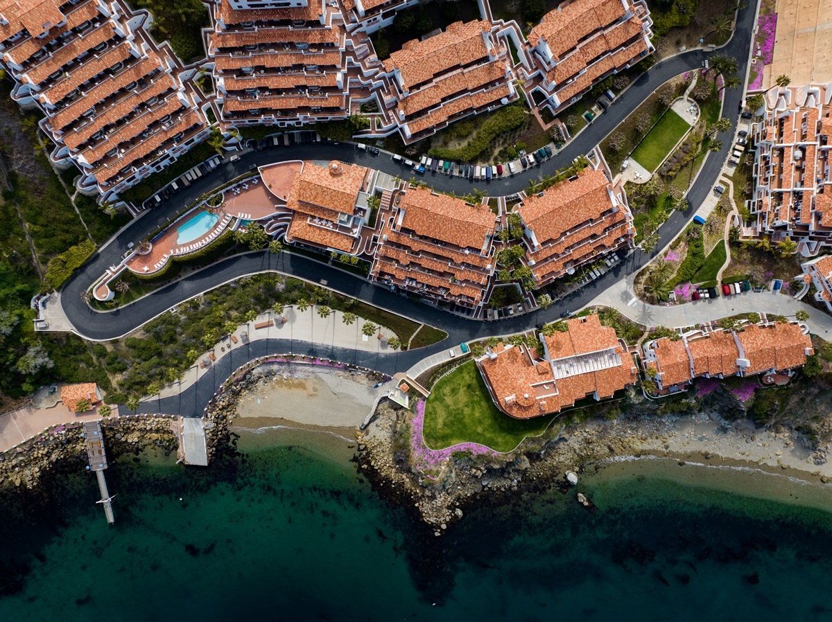 Aerial top view of sea waves crashing against the shoreline of Hamilton Cove