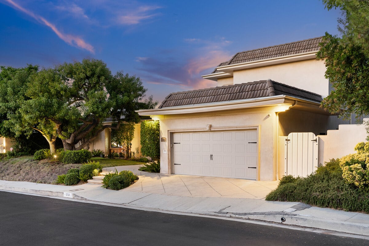 House at dusk, surrounded by greenery in California